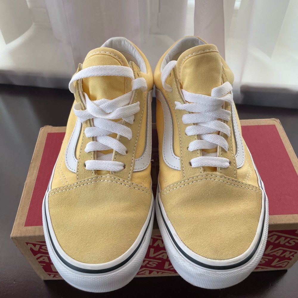 Low top yellow Vans.